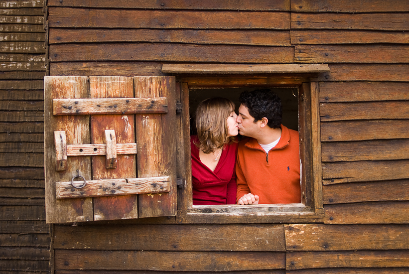 couple kissing in window in northern virginia