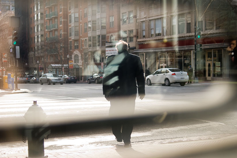 man crossing sidewalk