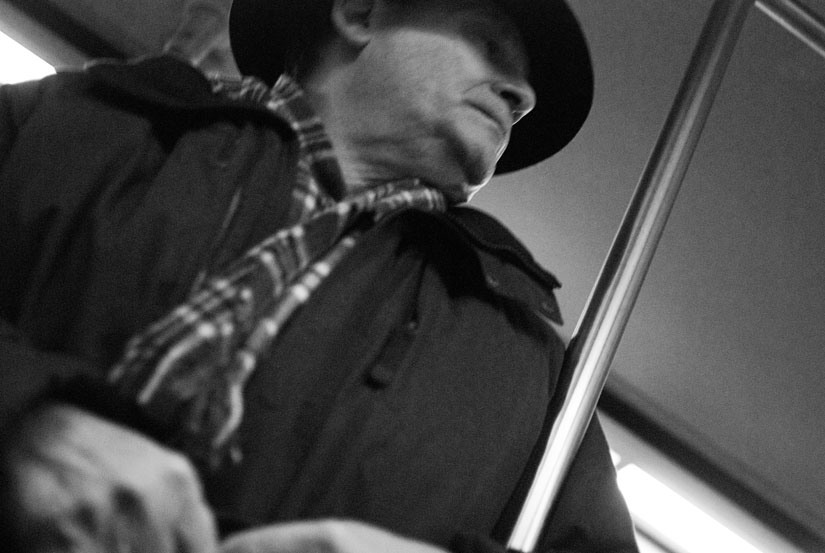 underneath dude's chin on the metro train