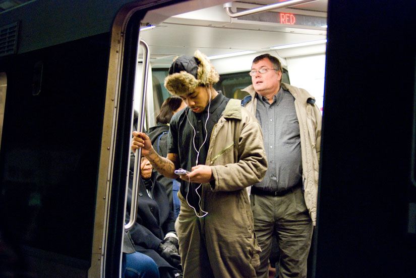 guy checking his ipod on the dc metro