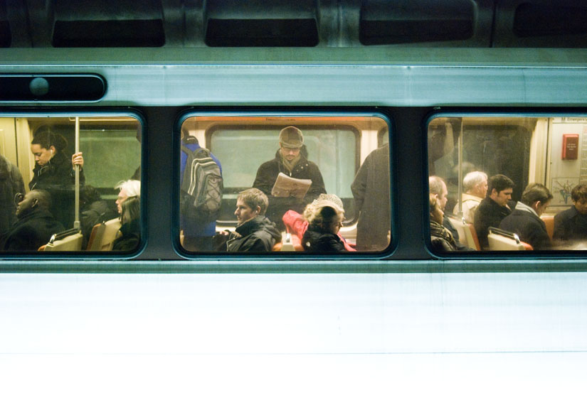 three people looking different ways on the dc metro