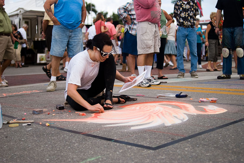 girl drawing flamingo in chalk