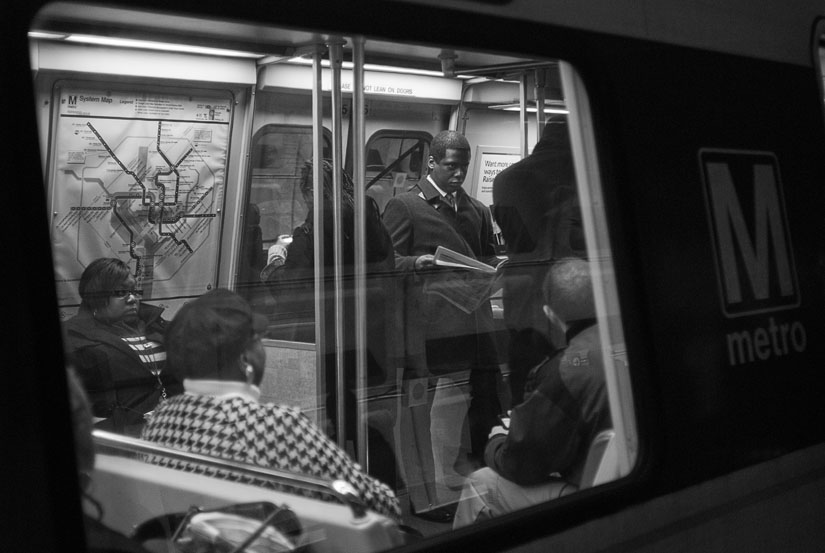 man reading a paper on the train