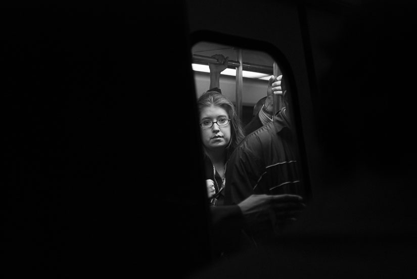 lady on the metro in a small window