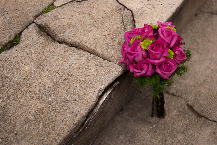 pink and green bridesmaid bouquet on stone stairs