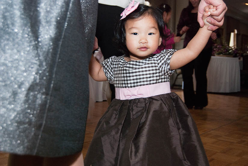 little girl dancing at the wedding reception