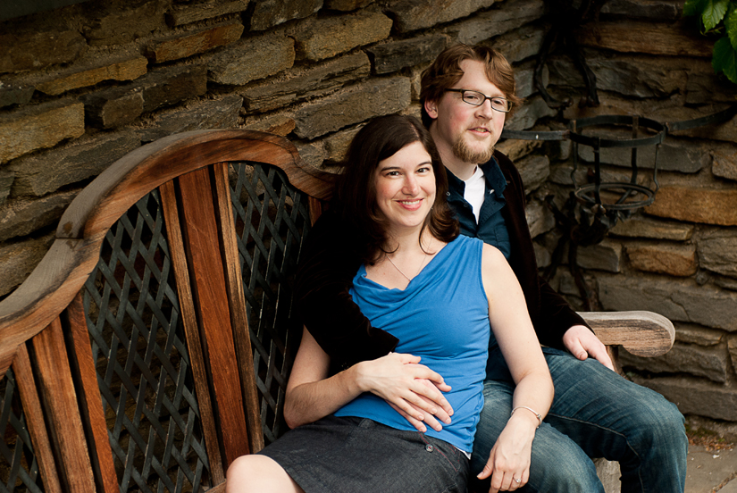 cute couple sitting on a bench at dumbarton oaks