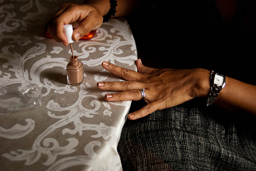 woman applying nail polish for wedding