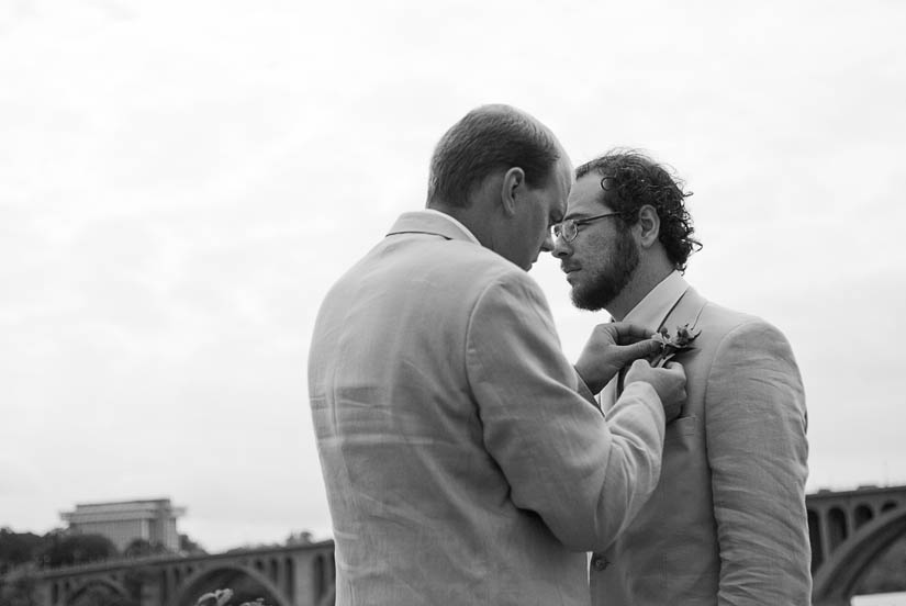 groomsmen put on boutennierres