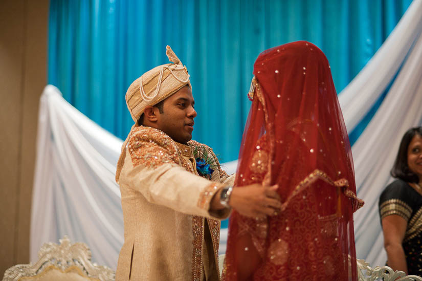 groom removes bride's veil
