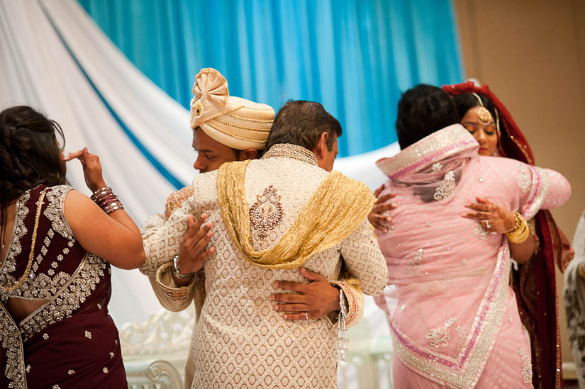 groom and bride hug family members