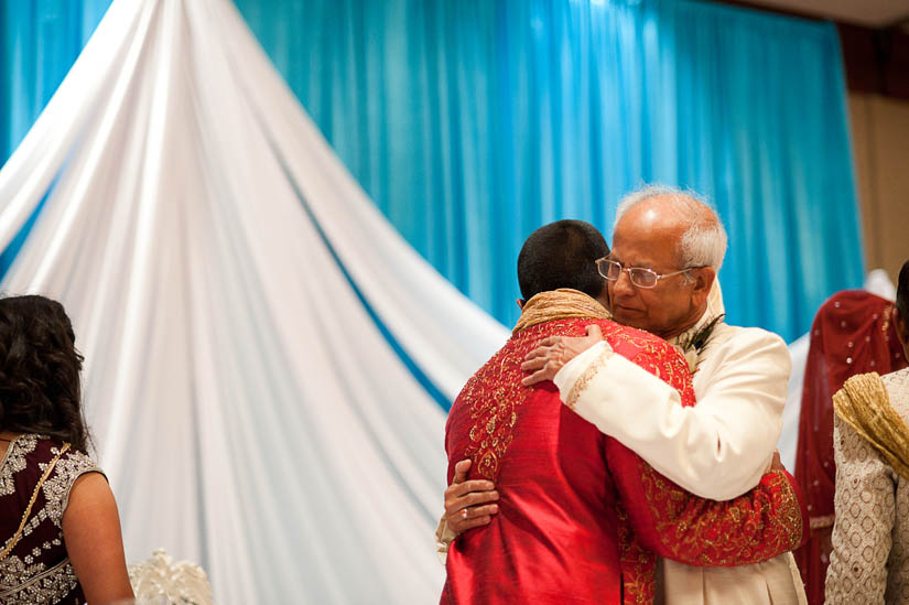 father of bride hugs brother