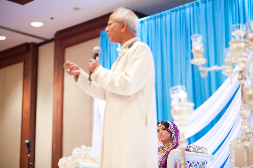 bride looks up at father giving speech