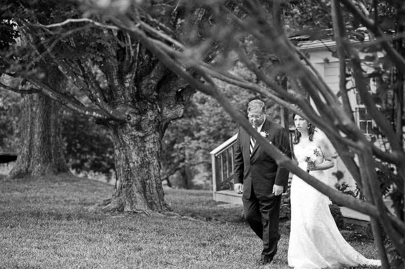 bride walks down the aisle with her father