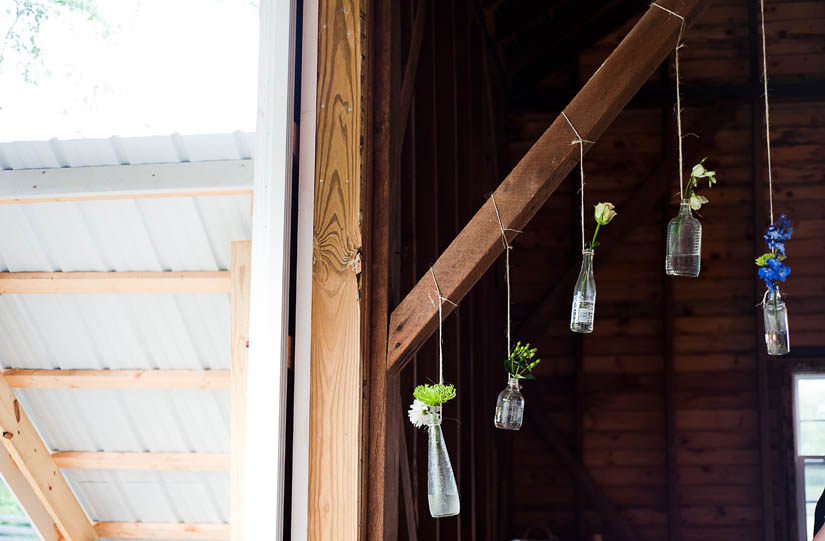 hanging bottles with flowers at the wedding reception