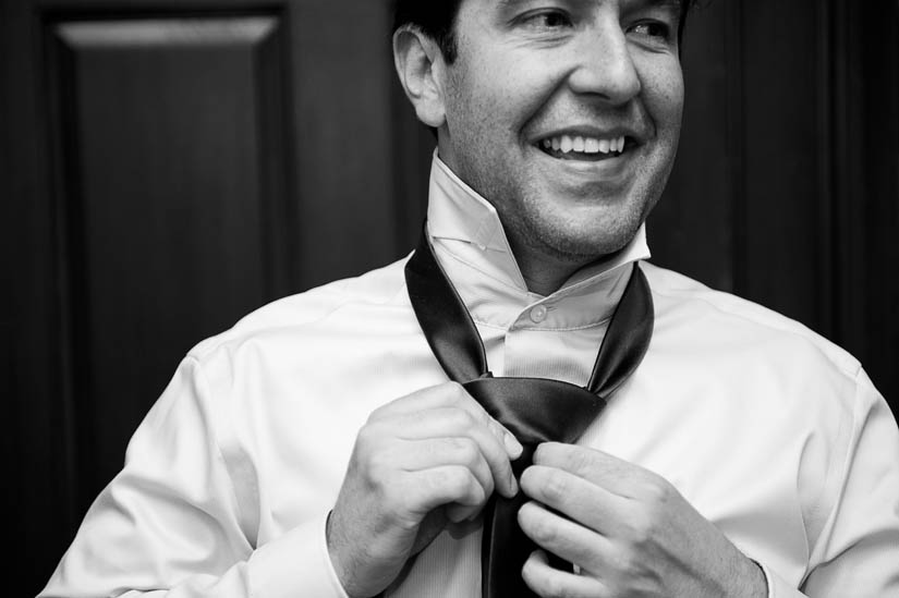 groom tying his tie