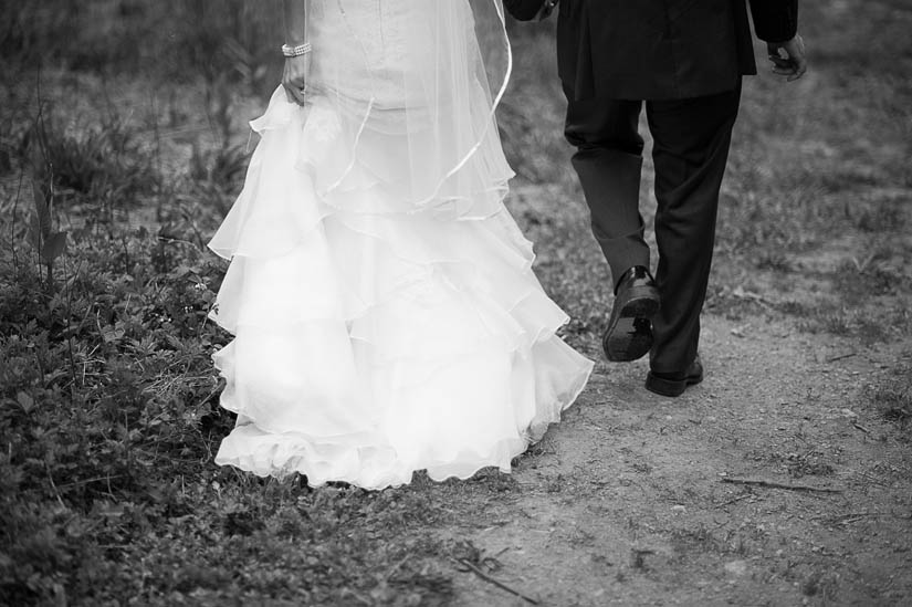 bride and groom walking in black and white