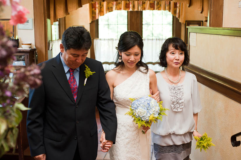 parents of the bride walking her to altar