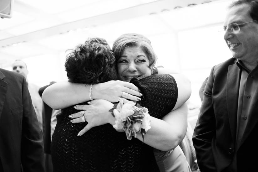 mother of the groom hugging relative