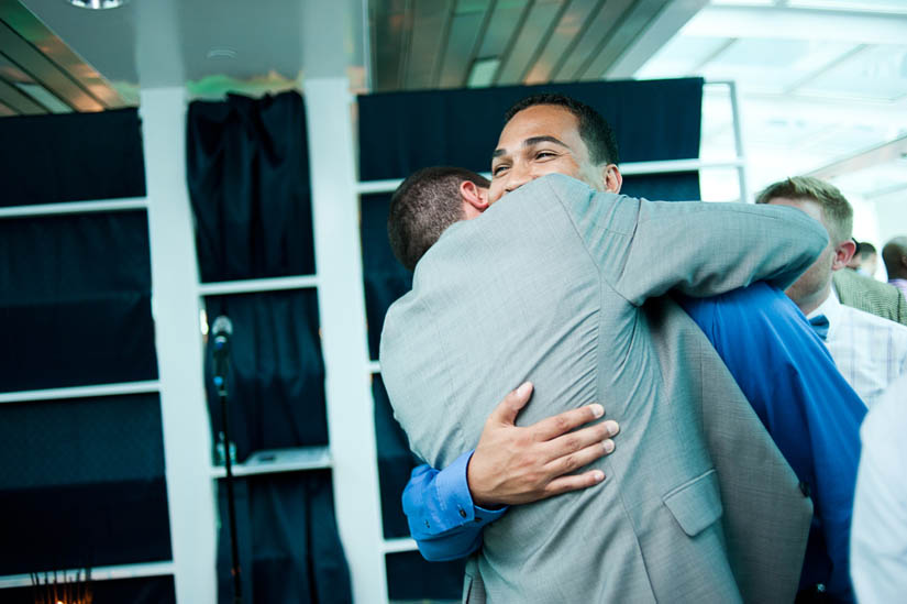 friend hugging groom