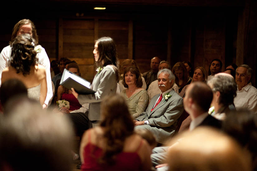 father of the bride looks on during ceremony