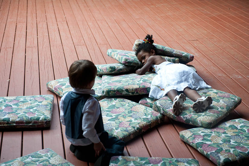 kids playing on couches during wedding reception