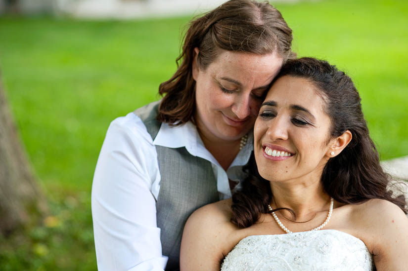 brides cuddling after getting married