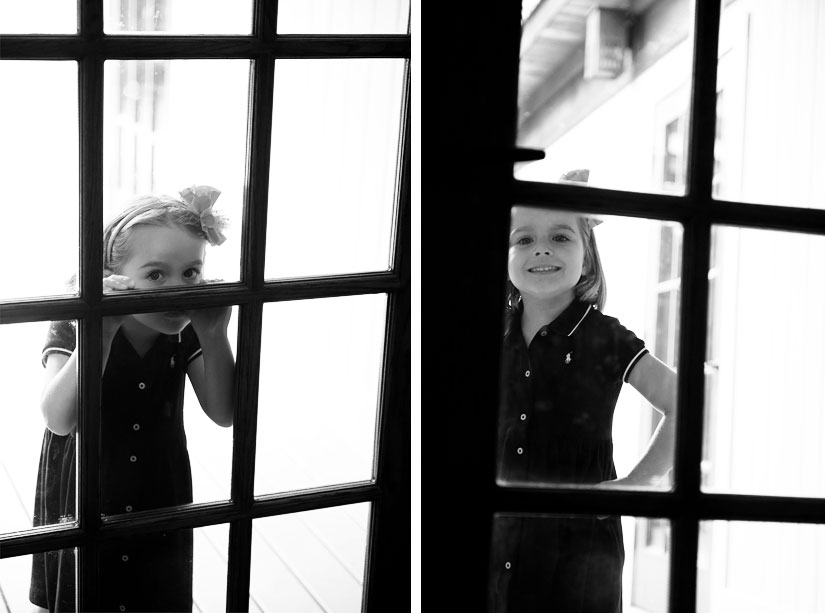 little girl playing in a window