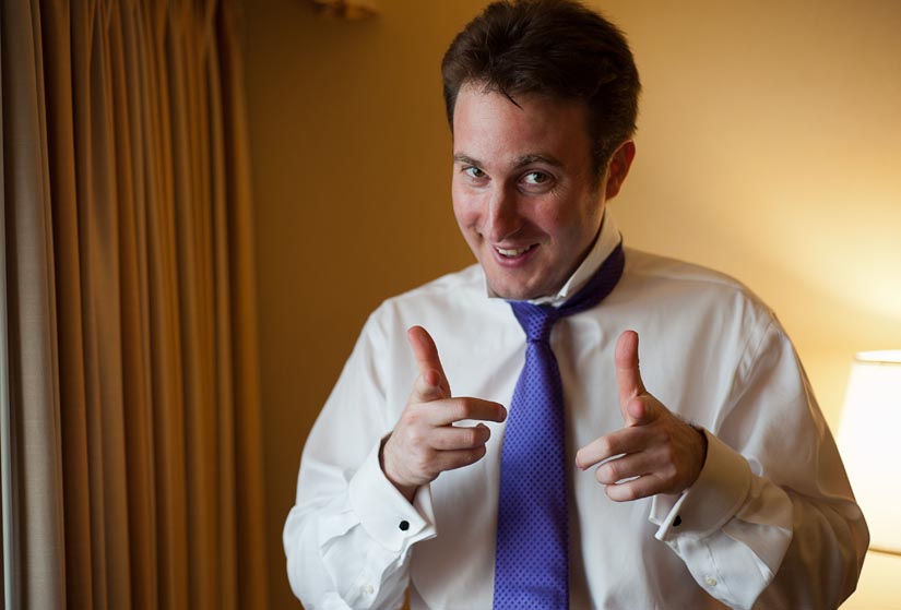 groom doing the guns with purple tie