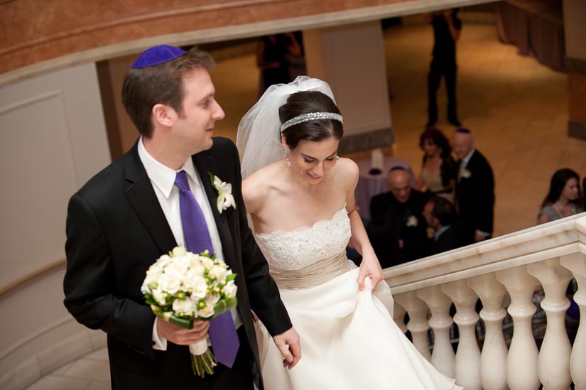 bride and groom coming upstairs at national museum for women in the arts