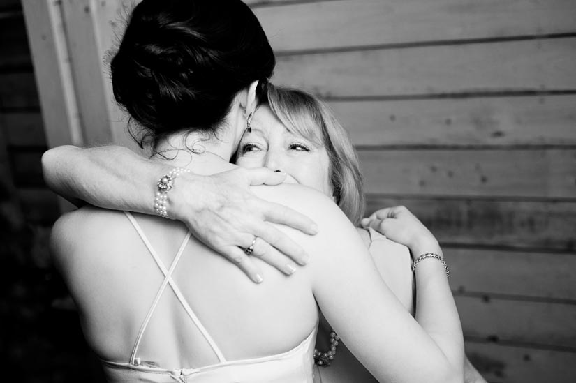 mom hugs daughter on wedding day
