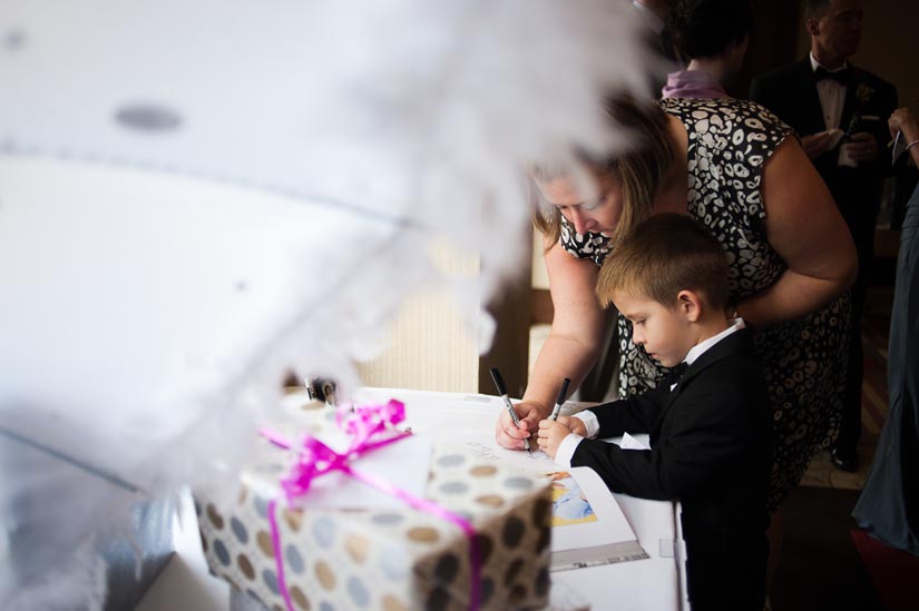 little boy signing guest book