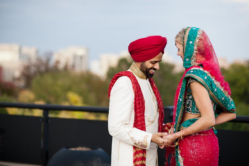 bride and groom laughing on arlington rooftop