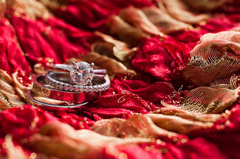wedding rings on red scarf