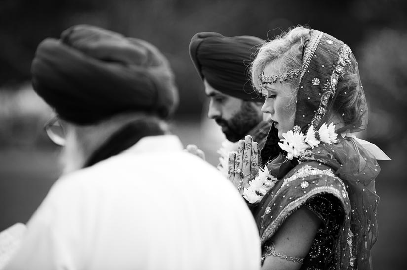 bride praying at sikh wedding ceremony