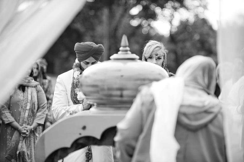 bride and groom near the holy book