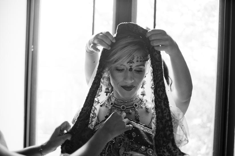 bride getting sari put on