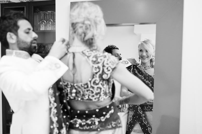 groom helps bride dress