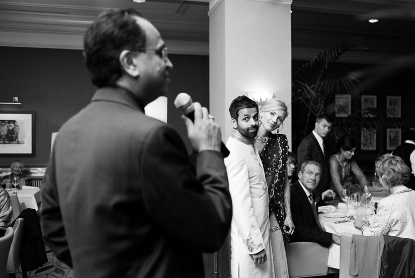 bride and groom look on during speeches