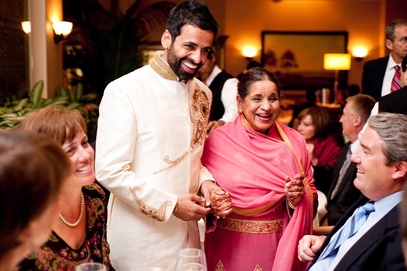 groom and his mother receive guests