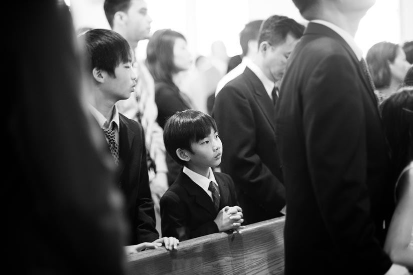 boy praying during church wedding