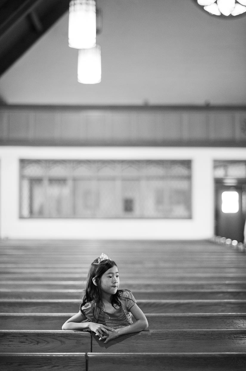 little girl in the pews at a wedding ceremony