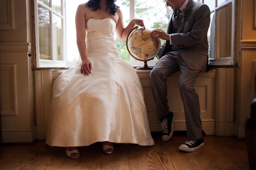 couple play with a globe during portraits