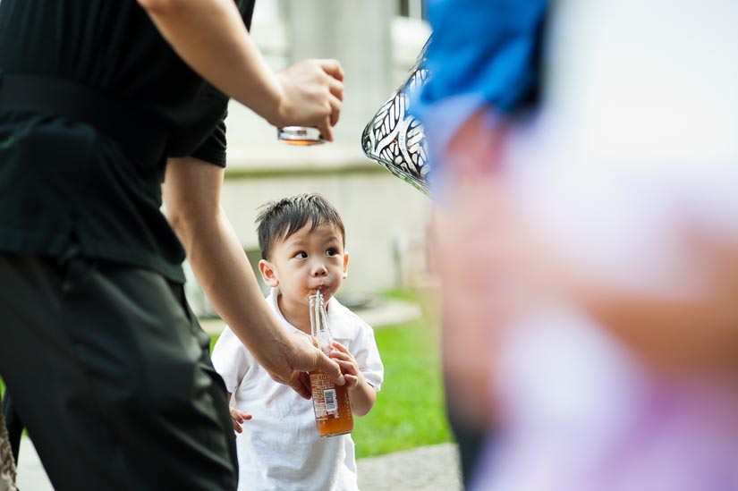 little boy drinks from a straw