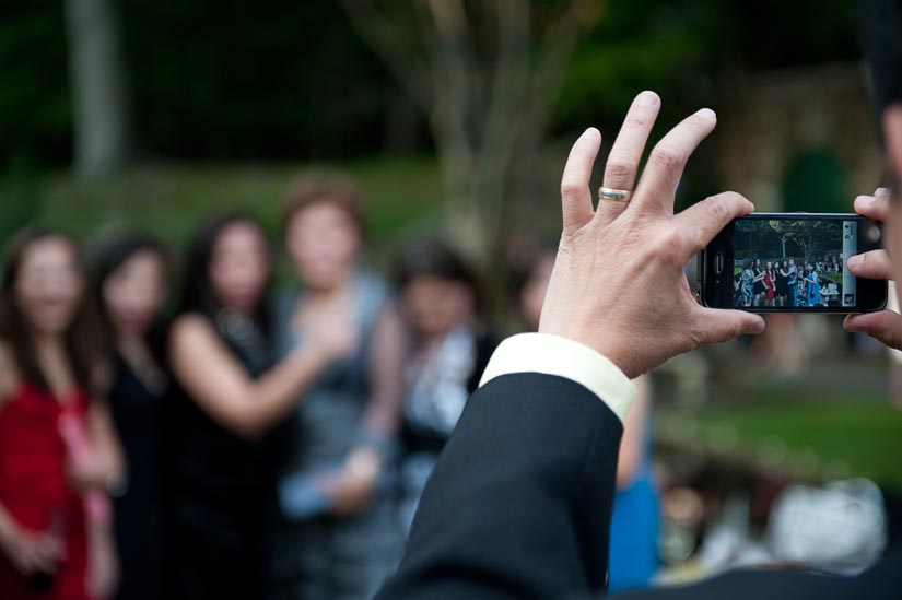 guest takes a photo of a family