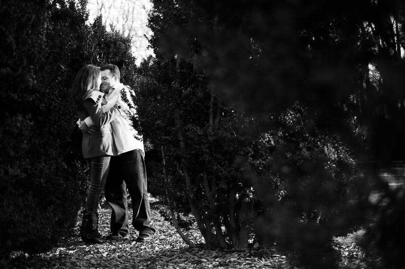 couple hugging in bushes