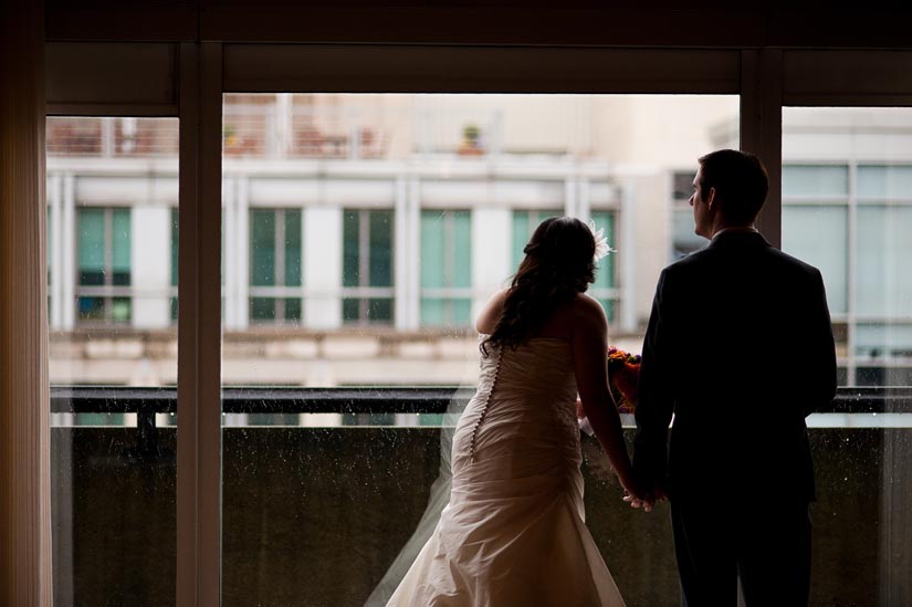 bride and groom watch the snow in washington, dc