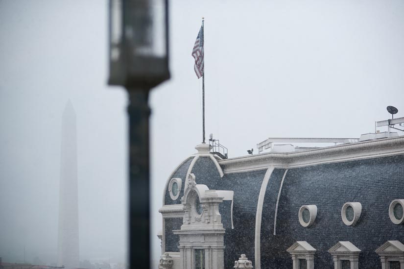 snow falling in october with washington monument