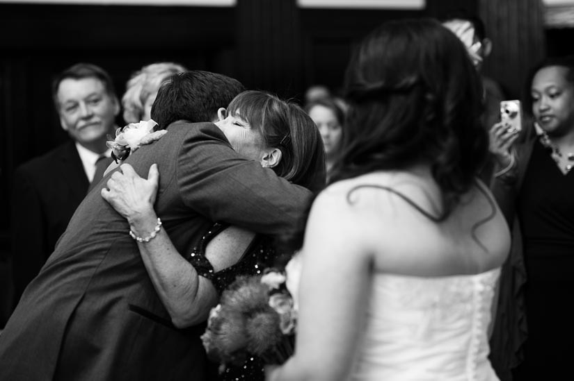 groom hugs his mother-in-law during the ceremony