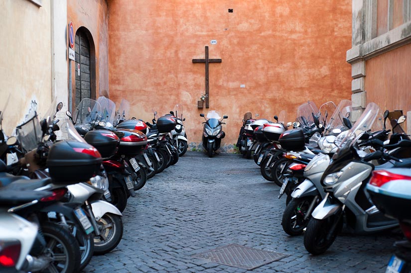 cross and vespas in rome, italy